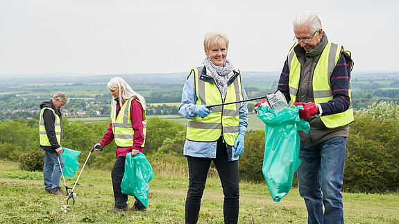 Group Of Helpful Seniors Collecting Litter In Countryside group, senior, seniors, retired, retirement, collecting, litter, rubbish, trash, cleaning up, tidying, garbage, volunteer, volunteering, helping, helpful, community, countryside, nature, responsibility, man, men, woman, women, male, female, portrait, looking at camera, friends, four people, people, person, together, happy, smiling, outdoors, caucasian, 60s, sixties, 80s, eighties, horizontal, full length, front view, environment, good neighbor, good neighbour